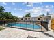 Backyard pool with black safety fence, surrounded by a brick paver patio at 5601 16Th N St, St Petersburg, FL 33703