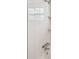 Bathroom featuring a white tiled shower with chrome shower head and mounted shelving at 5601 16Th N St, St Petersburg, FL 33703