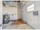 Utility room with water heater, white walls, and concrete floor at 5601 16Th N St, St Petersburg, FL 33703