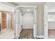 Walk-in closet with vinyl floors and organized shelving, adjacent to the bathroom and bedroom at 5601 16Th N St, St Petersburg, FL 33703