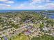Aerial view of a neighborhood with lush greenery, waterways, and blue sky background at 879 De Soto Blvd, Tarpon Springs, FL 34689