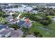 Aerial view of the home with a large lake and lush foliage in the background at 879 De Soto Blvd, Tarpon Springs, FL 34689
