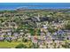 An aerial view showcases the home's location within a residential neighborhood near the water at 879 De Soto Blvd, Tarpon Springs, FL 34689