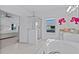Bathroom featuring a glass shower, soaking tub, and granite topped sink at 879 De Soto Blvd, Tarpon Springs, FL 34689