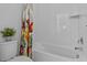 Clean bathroom featuring a toilet and tub with white tiles at 879 De Soto Blvd, Tarpon Springs, FL 34689