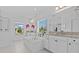 Bright bathroom with a soaking tub, tiled floor, and dual sink vanities at 879 De Soto Blvd, Tarpon Springs, FL 34689