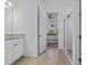 Bright bathroom featuring a granite-topped vanity, and a glass-enclosed shower at 879 De Soto Blvd, Tarpon Springs, FL 34689