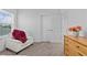 Relaxing bedroom featuring a cozy chair, a wooden dresser, and bright natural light at 879 De Soto Blvd, Tarpon Springs, FL 34689