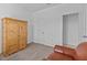 Neutral bedroom with a wooden wardrobe and view to an open doorway at 879 De Soto Blvd, Tarpon Springs, FL 34689