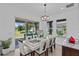 Bright dining room features a stylish light fixture and sliding doors to the backyard at 879 De Soto Blvd, Tarpon Springs, FL 34689