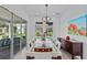Modern dining room with a large table, stylish chairs, and sliding glass doors to the backyard at 879 De Soto Blvd, Tarpon Springs, FL 34689