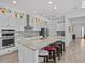 Kitchen featuring a large island with seating, stainless steel appliances and white cabinets at 879 De Soto Blvd, Tarpon Springs, FL 34689