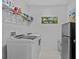 Modern laundry room with stainless steel fridge and shelving at 879 De Soto Blvd, Tarpon Springs, FL 34689
