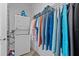 Efficient laundry room with stacked washer and dryer, plus clothing storage at 879 De Soto Blvd, Tarpon Springs, FL 34689