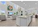 Open-concept living and kitchen area with a large island, and hardwood flooring at 879 De Soto Blvd, Tarpon Springs, FL 34689