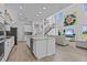Open floor plan with a modern kitchen, living room and staircase at 879 De Soto Blvd, Tarpon Springs, FL 34689