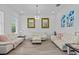 Elegant living room featuring white furniture, stylish flooring, and recessed lighting at 879 De Soto Blvd, Tarpon Springs, FL 34689