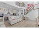 Spacious living room features soaring ceilings, an open floor plan, and a staircase to the second floor at 879 De Soto Blvd, Tarpon Springs, FL 34689