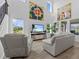 Sun-filled living room with tile floors, plush seating, and a wall-mounted television at 879 De Soto Blvd, Tarpon Springs, FL 34689