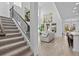 Bright, open living space with soaring ceilings, and a view of the staircase and modern decor at 879 De Soto Blvd, Tarpon Springs, FL 34689