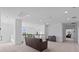 Bright and airy loft features neutral walls and carpeting, sofa and decorative wrought iron railing at 879 De Soto Blvd, Tarpon Springs, FL 34689