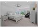 Bright and spacious main bedroom with a ceiling fan, plants and natural light at 879 De Soto Blvd, Tarpon Springs, FL 34689