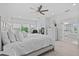 Large main bedroom with a ceiling fan and natural light from multiple windows at 879 De Soto Blvd, Tarpon Springs, FL 34689