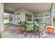 Outdoor patio area with brick pavers, comfortable green seating, and views of the landscaped backyard at 879 De Soto Blvd, Tarpon Springs, FL 34689