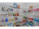 Organized pantry with wire shelving, filled with various food and household items, maximizing storage space at 879 De Soto Blvd, Tarpon Springs, FL 34689