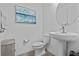 Elegant powder room featuring a pedestal sink, modern faucet, and stylish decor at 879 De Soto Blvd, Tarpon Springs, FL 34689