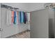 Organized walk-in closet with hanging clothes and shelving at 879 De Soto Blvd, Tarpon Springs, FL 34689