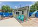 Charming backyard featuring a shed, seating area, and landscaping at 9201 86Th Ave, Seminole, FL 33777