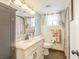 Charming bathroom featuring a marble vanity, decorative shower curtain, and seaside accents at 9201 86Th Ave, Seminole, FL 33777