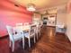 Inviting dining room with hardwood floors, modern light fixture, and open view into the adjacent kitchen at 9201 86Th Ave, Seminole, FL 33777