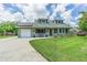 Charming single-story home with well-manicured lawn, brick exterior, solar panels, and a long driveway at 9201 86Th Ave, Seminole, FL 33777