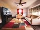 Cozy living room features an entertainment center, sofas, a window, and a colorful area rug at 9201 86Th Ave, Seminole, FL 33777