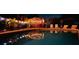 Backyard pool at night with ambient lighting, pergola-covered bar, and lounge seating at 9201 86Th Ave, Seminole, FL 33777