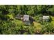 An aerial view displays a secluded property nestled among mature trees, featuring a pool at 9298 Carr Rd, Riverview, FL 33569