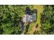 Aerial view of a home with a pool and covered patio surrounded by towering trees at 9298 Carr Rd, Riverview, FL 33569