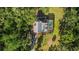 A beautiful home with a pool is surrounded by lush trees and greenery in this captivating aerial view at 9298 Carr Rd, Riverview, FL 33569