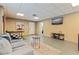 Basement with table tennis, a large TV, neutral colored walls, and concrete floor with a rug at 9298 Carr Rd, Riverview, FL 33569