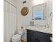 Clean bathroom featuring a vanity with marble countertop, white tile walls, and neutral decor at 9298 Carr Rd, Riverview, FL 33569