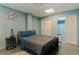 Finished basement bedroom with comfortable bedding, storage, and minimalist decor at 9298 Carr Rd, Riverview, FL 33569