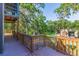 Wooden deck overlooking a green, sprawling yard, offering an outdoor living space surrounded by trees at 9298 Carr Rd, Riverview, FL 33569