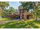 Rear exterior of home with elevated screened-in porch, elevated deck, and backyard trees at 9298 Carr Rd, Riverview, FL 33569