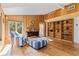 Well-lit living room with wood accents, a cozy chair, and views of the serene outdoors at 9298 Carr Rd, Riverview, FL 33569
