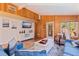 Bright living room with wood paneling, comfortable seating, and a large TV at 9298 Carr Rd, Riverview, FL 33569