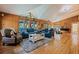 Cozy living room with wood paneling, large windows, and comfortable seating; natural light at 9298 Carr Rd, Riverview, FL 33569
