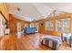 Bright and airy living room featuring wood paneled walls, hardwood floors and multiple windows for ample natural light at 9298 Carr Rd, Riverview, FL 33569