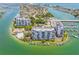 Stunning aerial view of waterfront condos with marina, pool, and Intracoastal Waterway access at 9495 Blind Pass Rd # 406, St Pete Beach, FL 33706